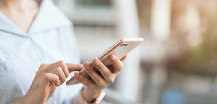 Taking Advantage of Open Banking women holding mobile phone